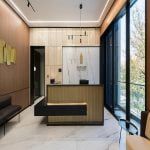 A contemporary office with sleek marble floors and elegant wood paneling.