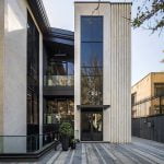 The entrance to a contemporary building featuring a spacious glass door.