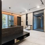 A contemporary office with sleek marble floors and elegant wood paneling.