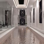 A modern indoor swimming pool with a black and white marble floor made of porcelain slab.